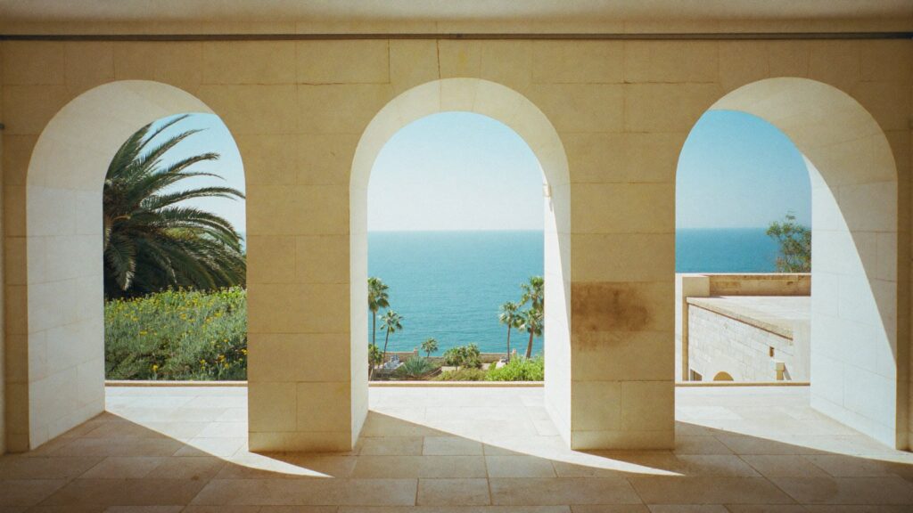 Three identical stone arches each opening on a different view, like the choice between a SIPP, a QROPS and a QNUPS.
